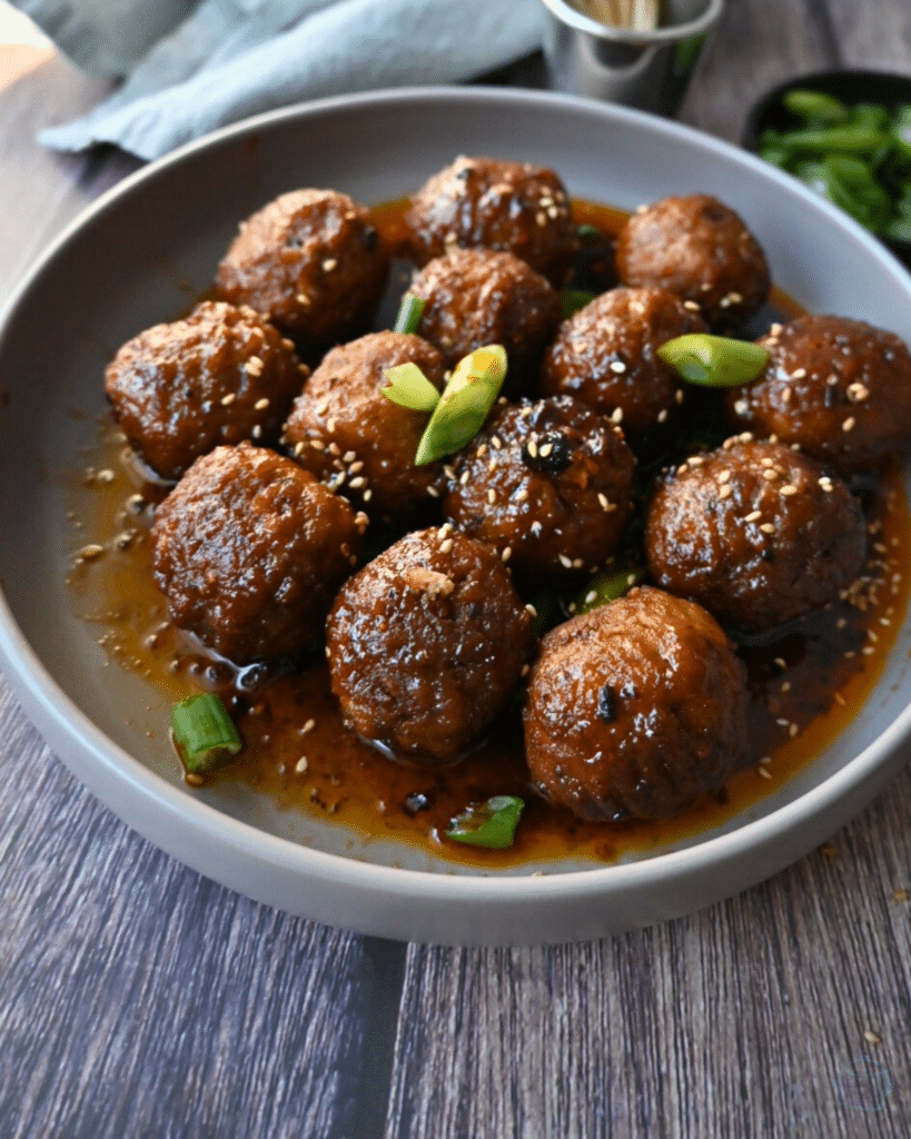 a bowl full of slow cooker spicy maple meatballs ready to serve