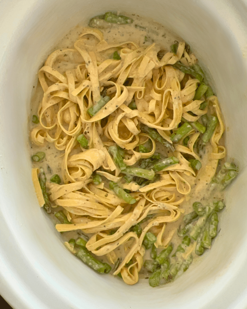 pasta, asparagus and sauce in a slow cooker