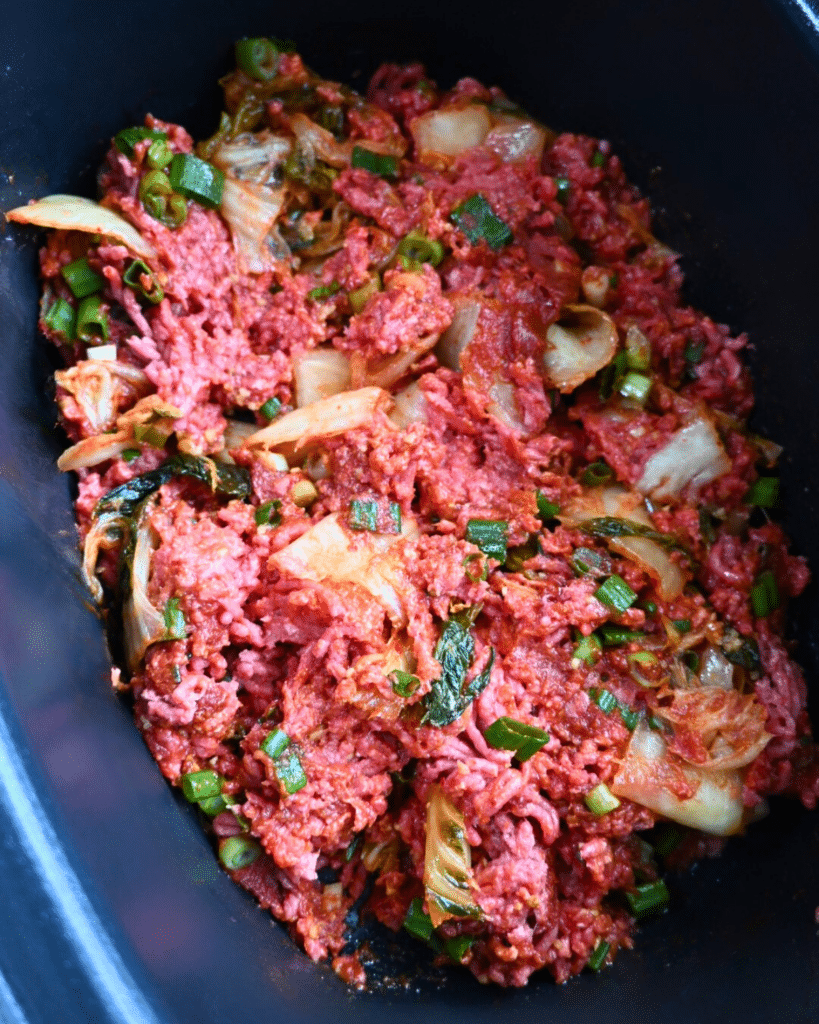 raw sloppy joe ingredients in crockpot before cooking