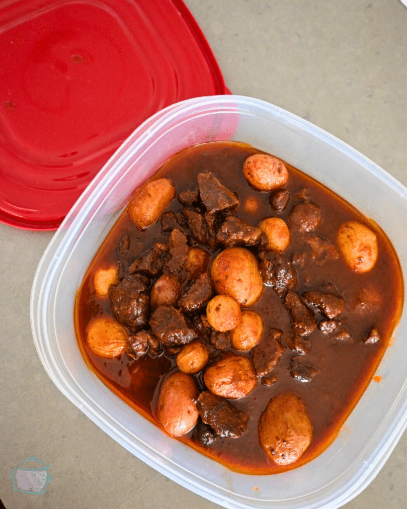 leftover steak bites and potatoes in a storage container