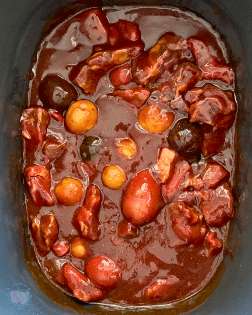steak bites and potatoes bbq sauce in a slow cooker before