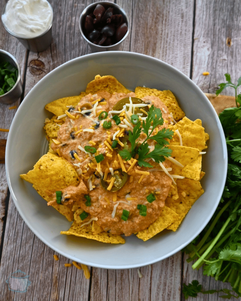 nacho chips topped with slow cooker ground chicken cheesy nacho sauce