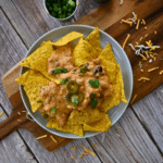 nacho chips topped with slow cooker ground chicken cheesy nacho sauce