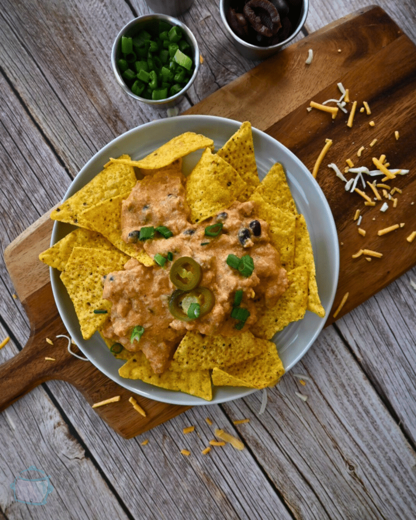 nacho chips topped with slow cooker ground chicken cheesy nacho sauce