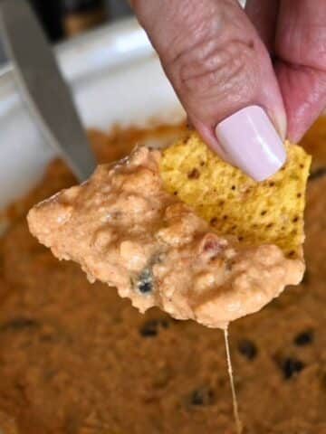 Ground chicken cheesy nacho topping on a chip