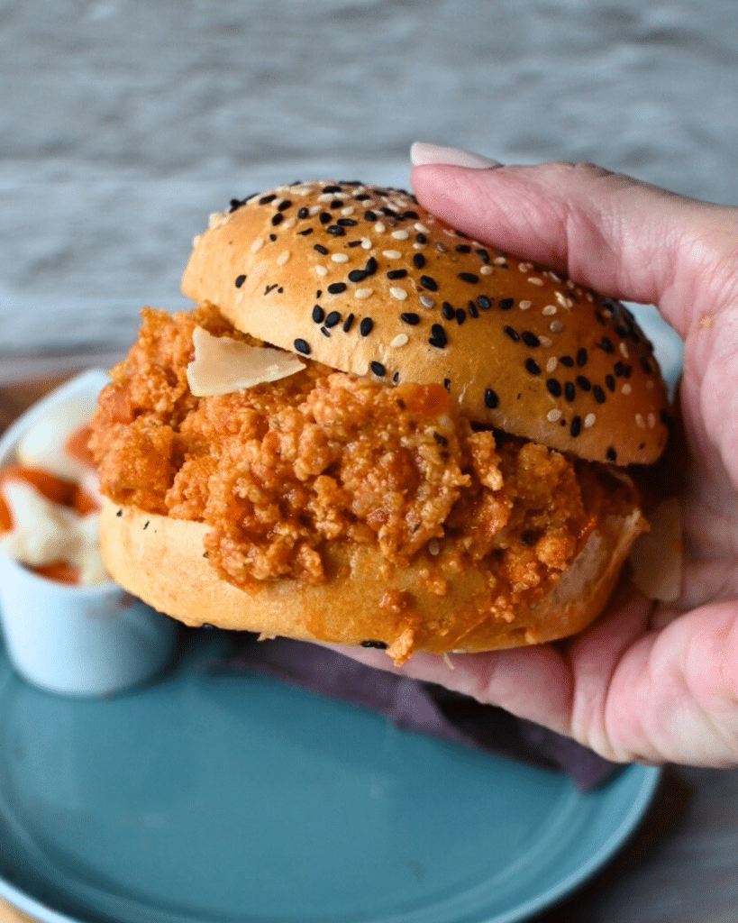 seeded bun filled with slow cooker ground chicken sloppy joes