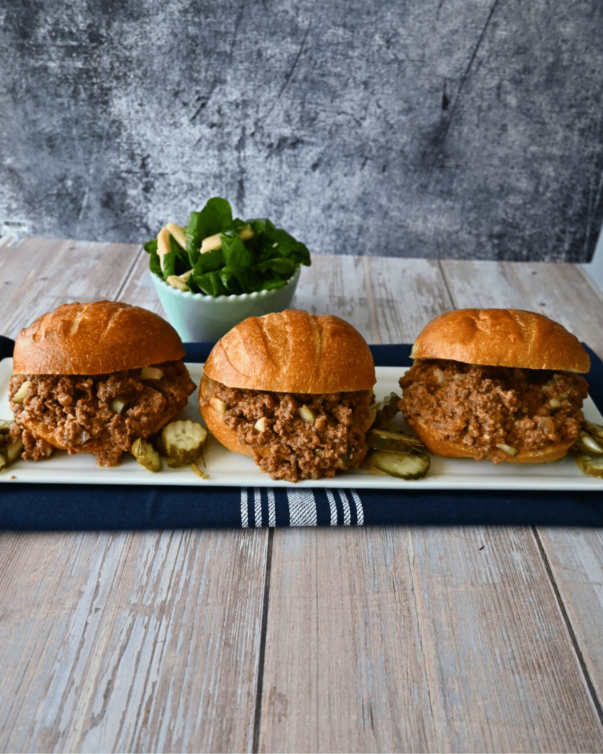 three dill pickle sloppy joe sandwiches on a tray