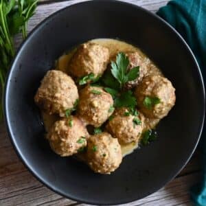air fryer meatballs in tahini sauce in a black bowl