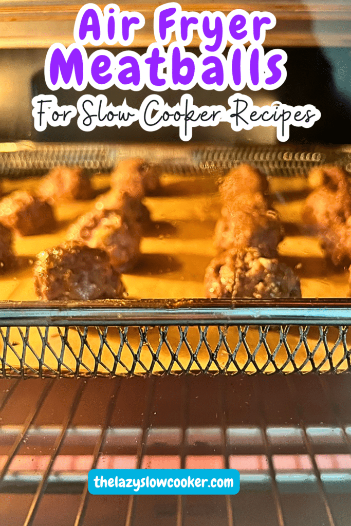 meatballs lined up on a an air fryer cooking tray in the air fryer