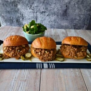three dill pickle sloppy joe sandwiches on a tray