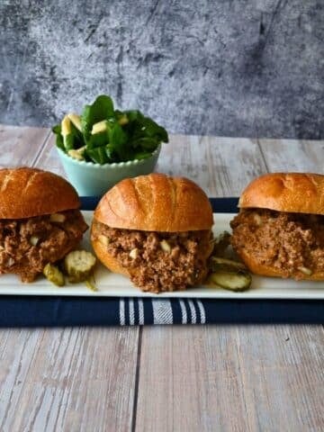 three dill pickle sloppy joe sandwiches on a tray