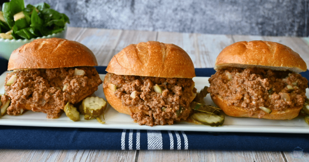 three dill pickle sloppy joe sandwiches on a tray