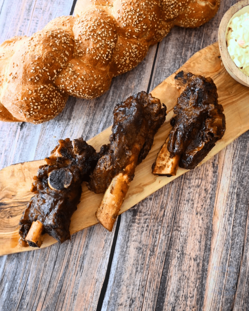 three ribs on a wooden serving tray