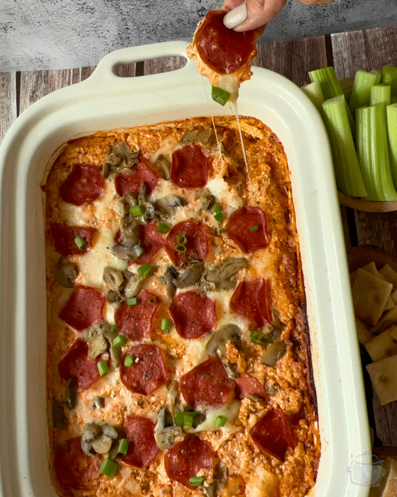 Gooey cheesy slow cooker cottage cheese pizza dip on a cracker