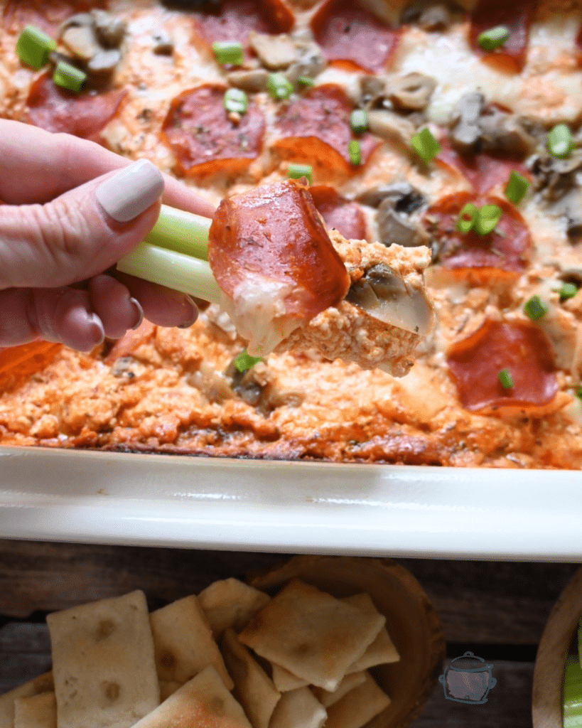 whipped cottage cheese pizza dip on a celery stalk