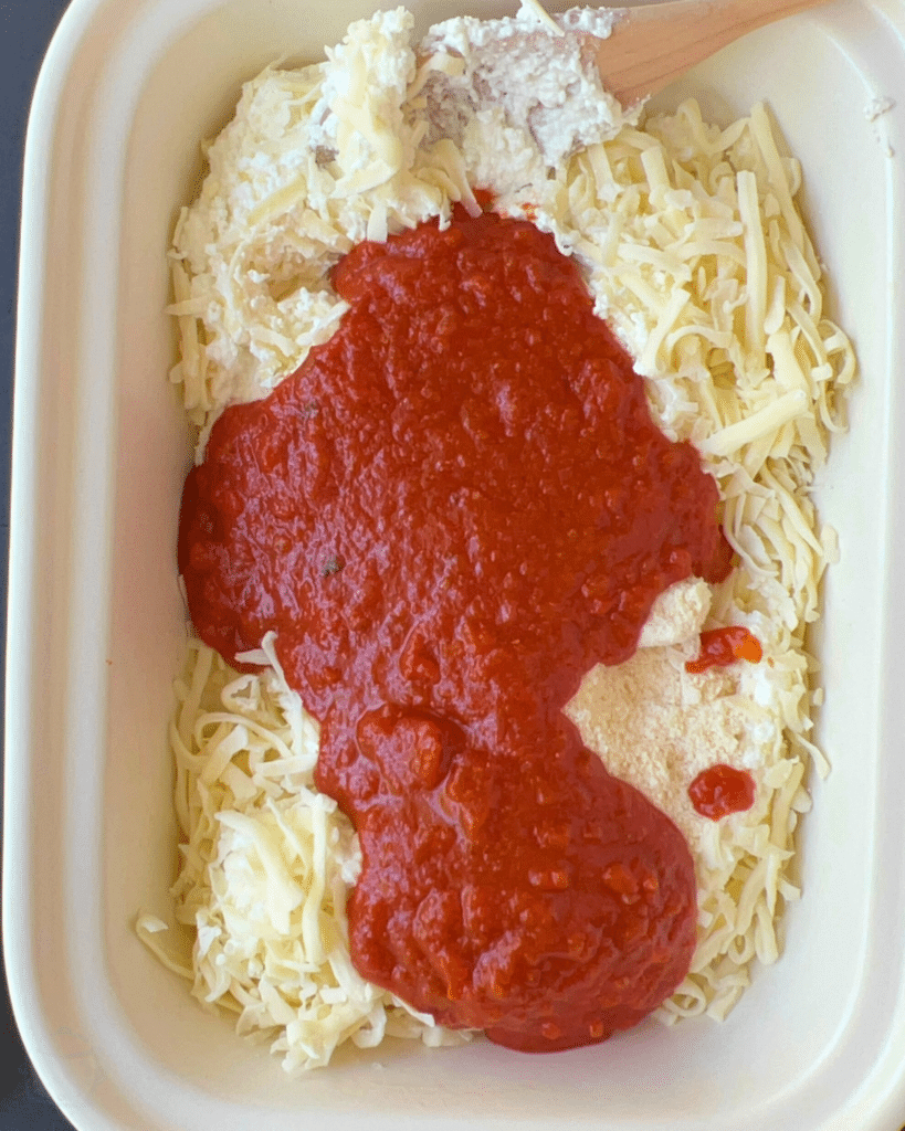 cheese and sauce in a crock pot before mixing