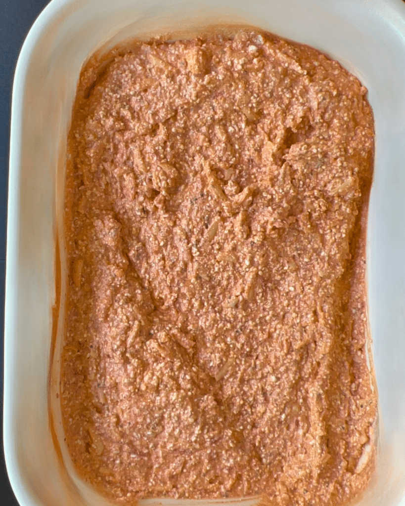 All pizza dip ingredients mixed in slow cooker before toppings are added