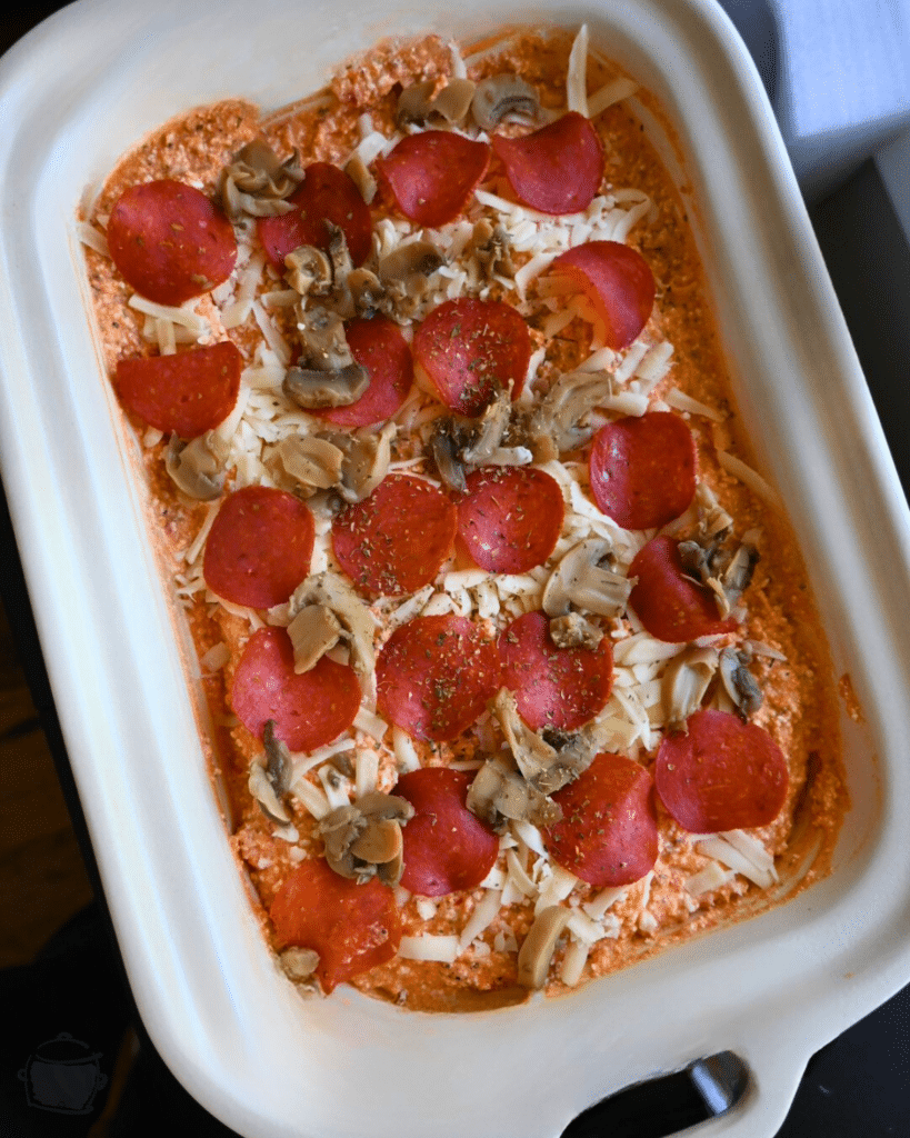 all cottage cheese pizza dip ingredients in slow cooker before cooking