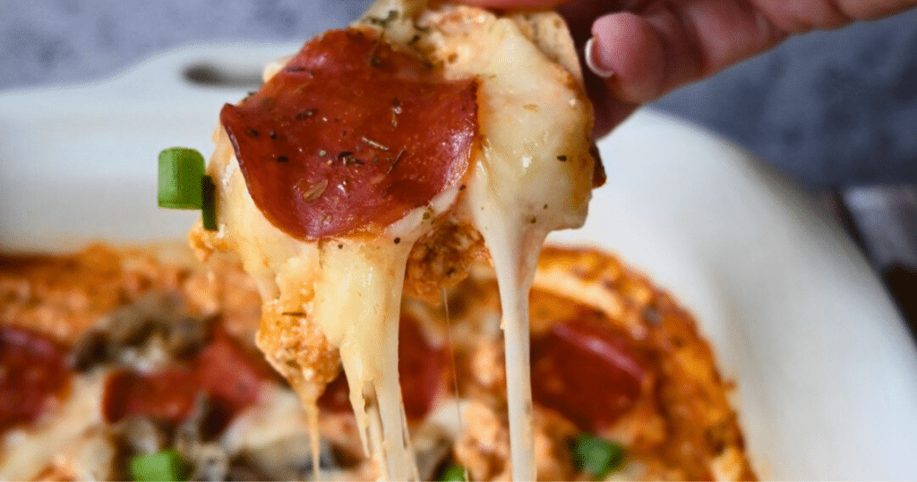 Gooey cheesy slow cooker cottage cheese pizza dip on a cracker