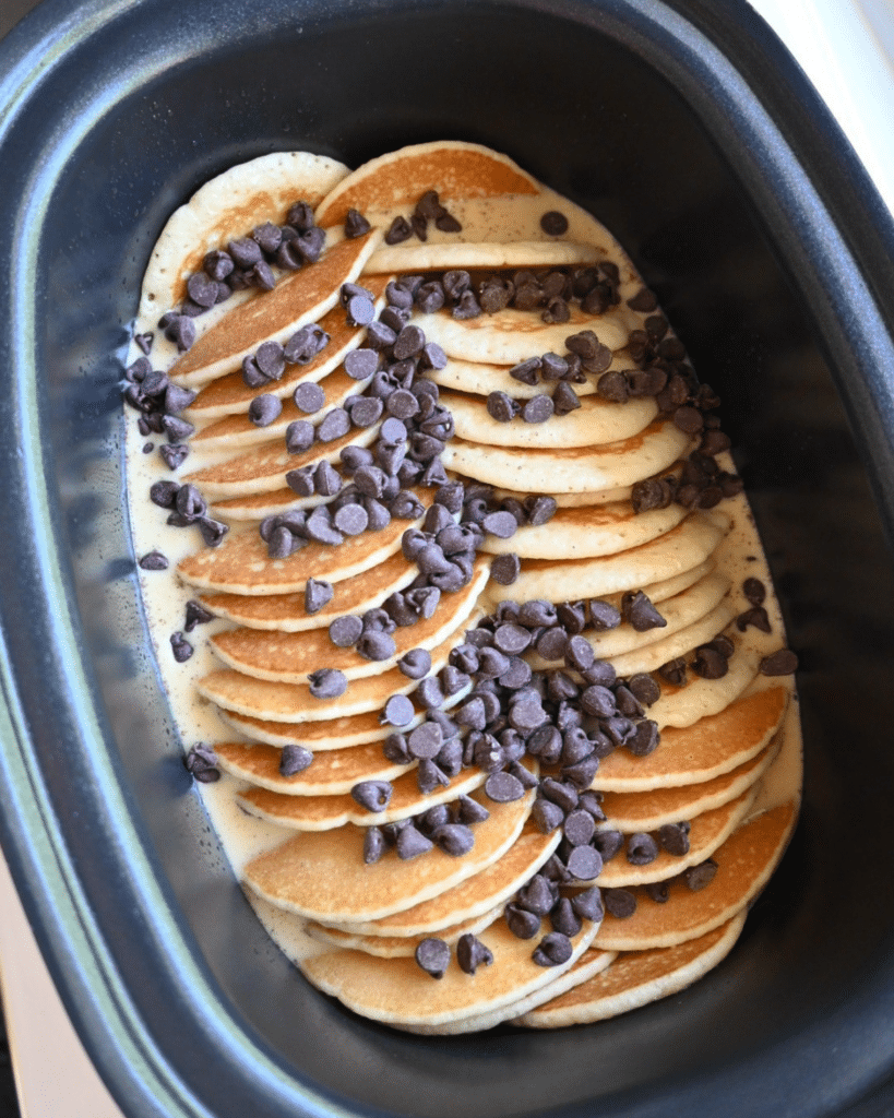 All ingredients for slow cooker pancake casserole in a slow cooker ready to cook