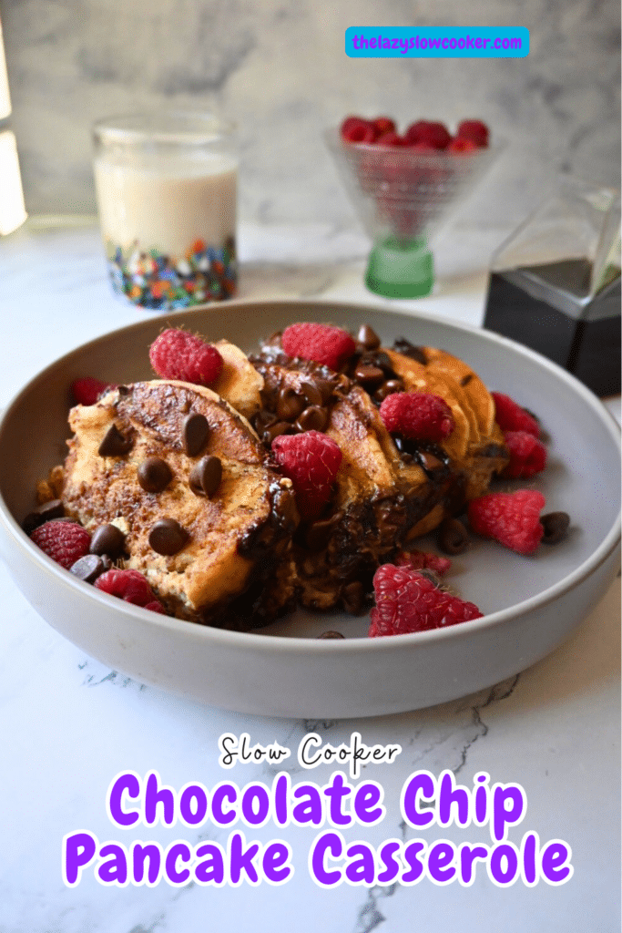 a bowl full of slow cooker chocolate chip pancake casserole topped with berries