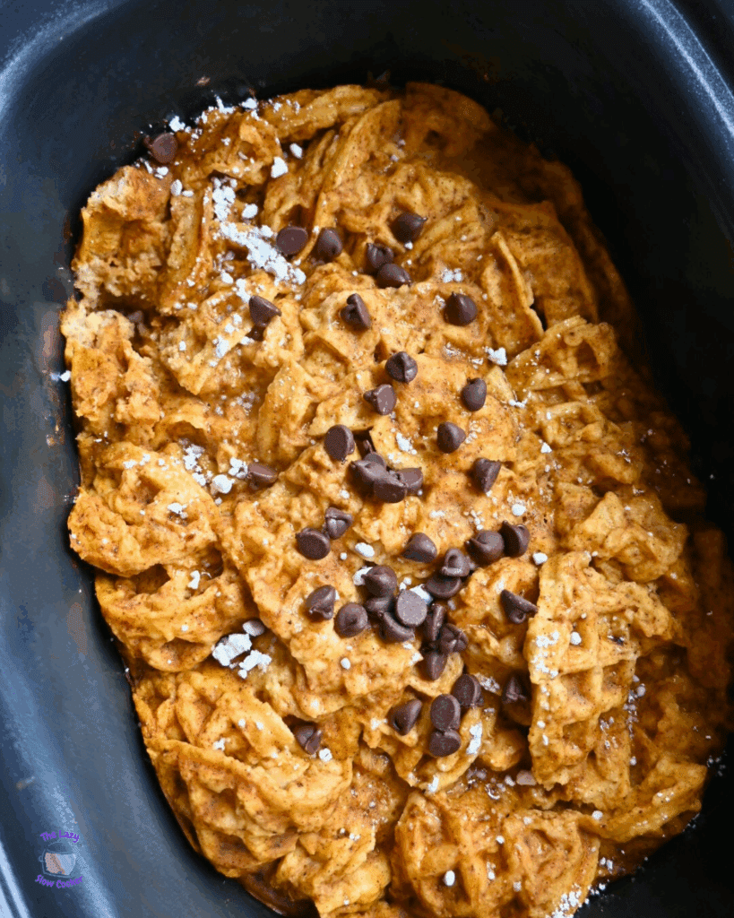 a slow cooker full of pumpkin waffle casserole ready to serve