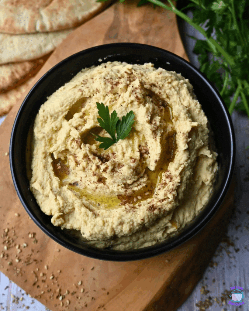 slow cooker hummus in a black bowl