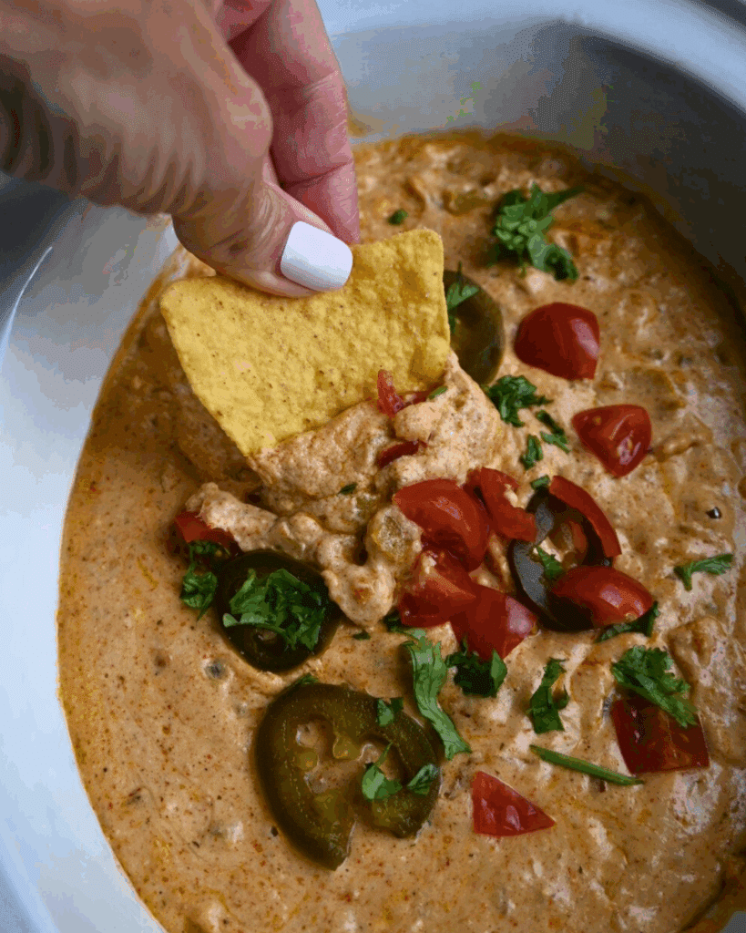 cottage cheese queso on a chip over a slow cooker full of the same