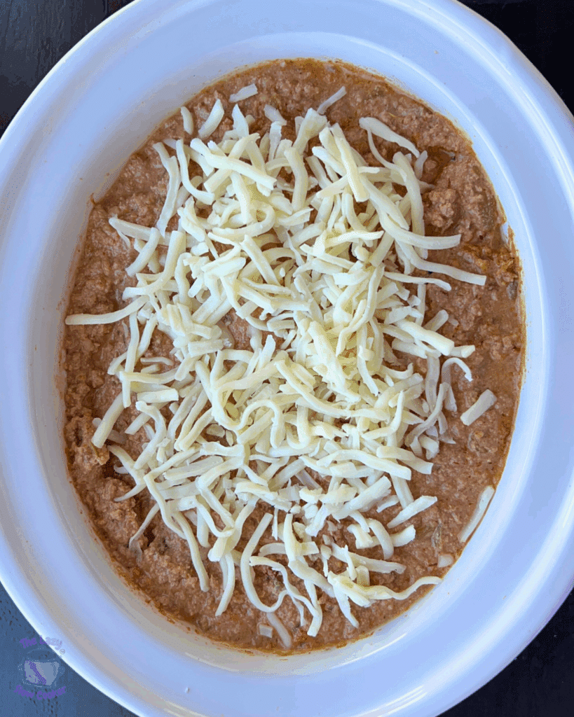 All cottage cheese taco dip ingredients in a slow cooker before cooking