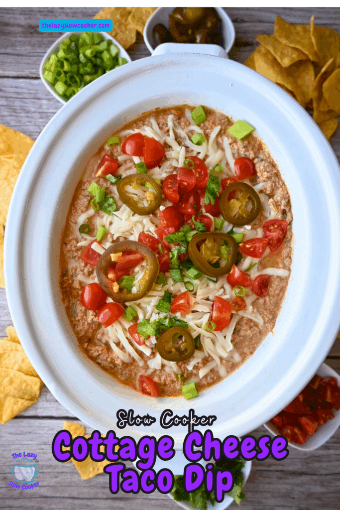 A crockpot full of cottage cheese taco dip with toppings