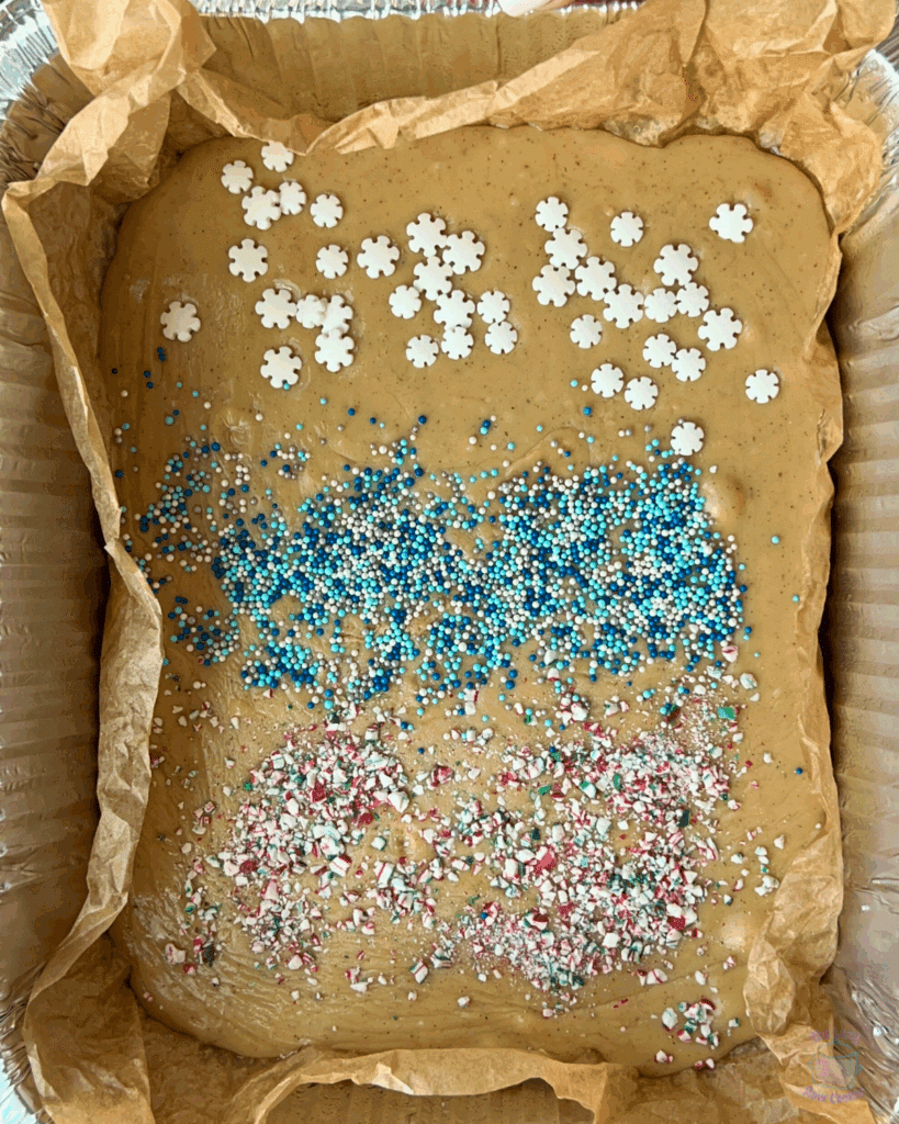 finished gingerbread fudge cooling in a foil pan with decorations.