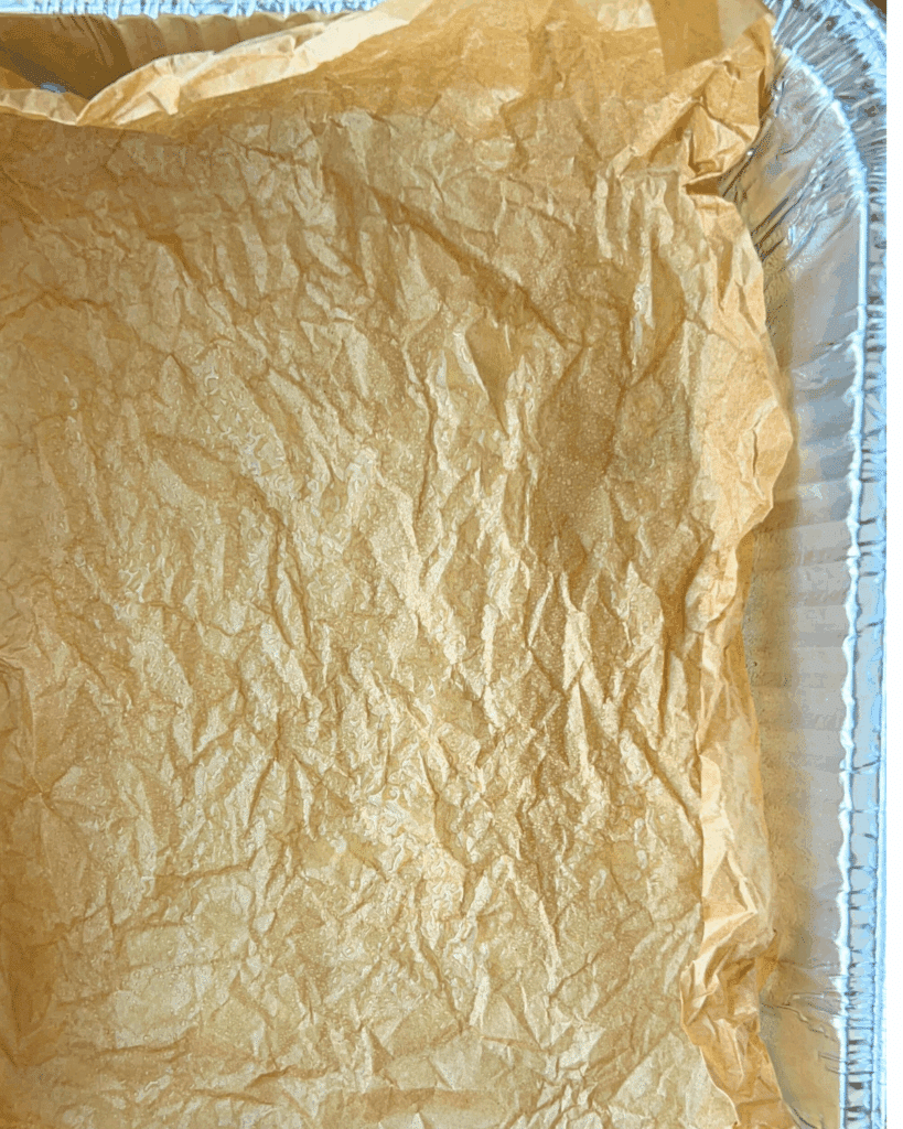 greased pan lined with greased parchment paper.