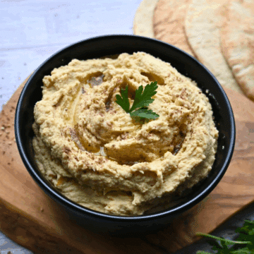 slow cooker hummus in a black bowl