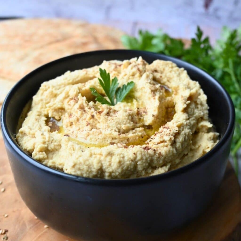 slow cooker hummus in a black bowl