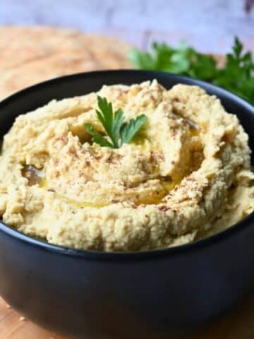 slow cooker hummus in a black bowl