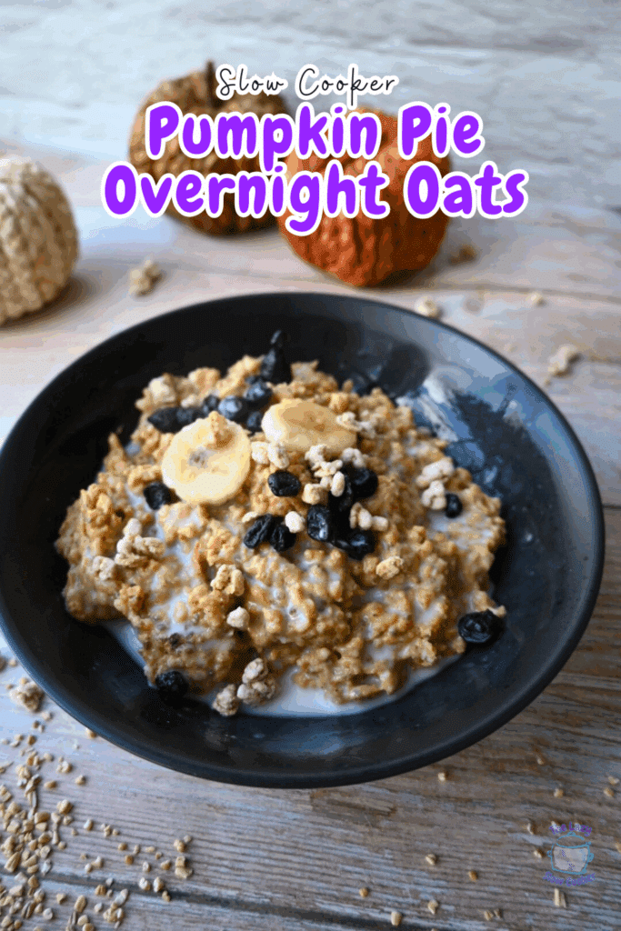 a black bowl filled with pumpkin pie overnight slow cooker oats topped with blueberries and bananas