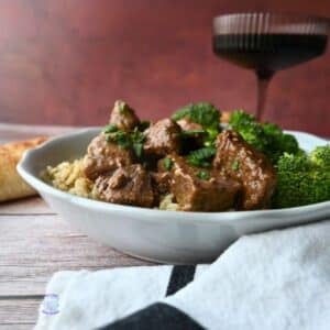 slow cooker steak bites with broccoli on a bed a rice