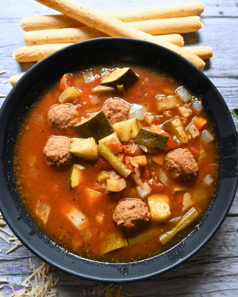 a bowlful of vegetable soup with meatballs made in a slow cooker