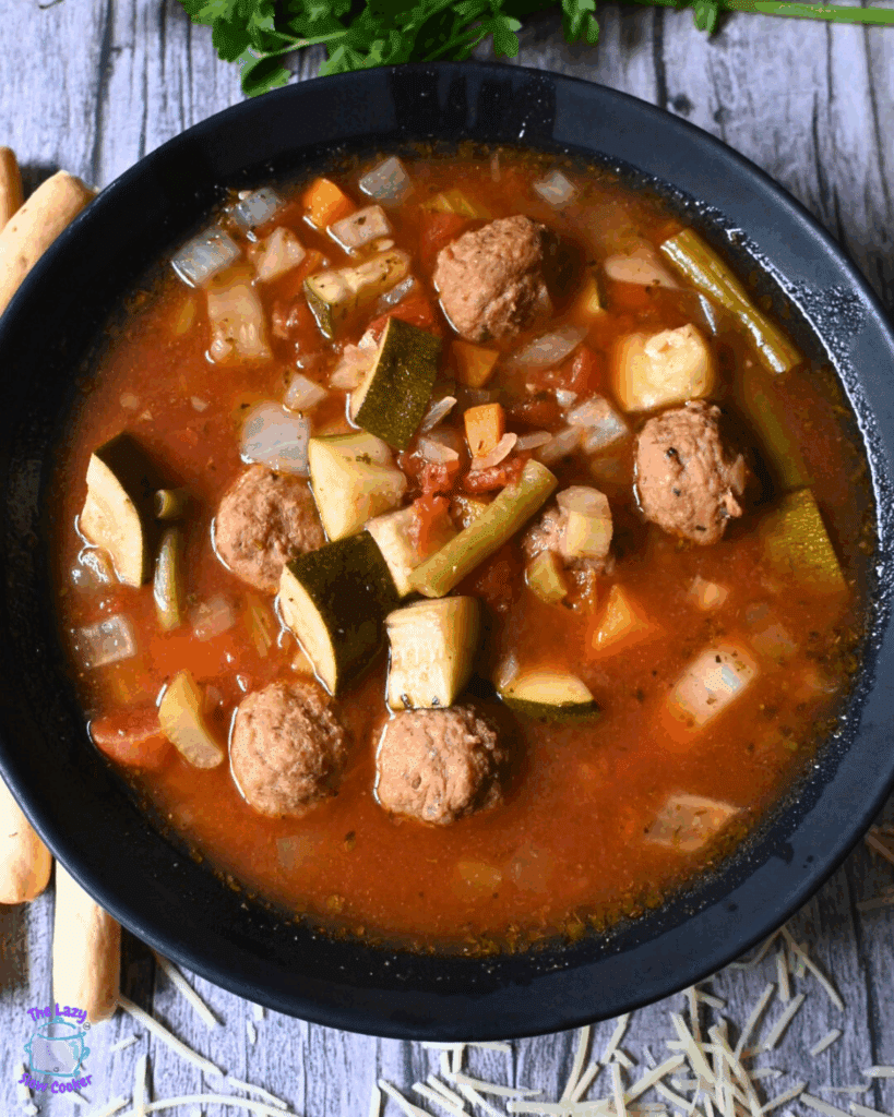 a bowlful of vegetable soup with meatballs made in a slow cooker