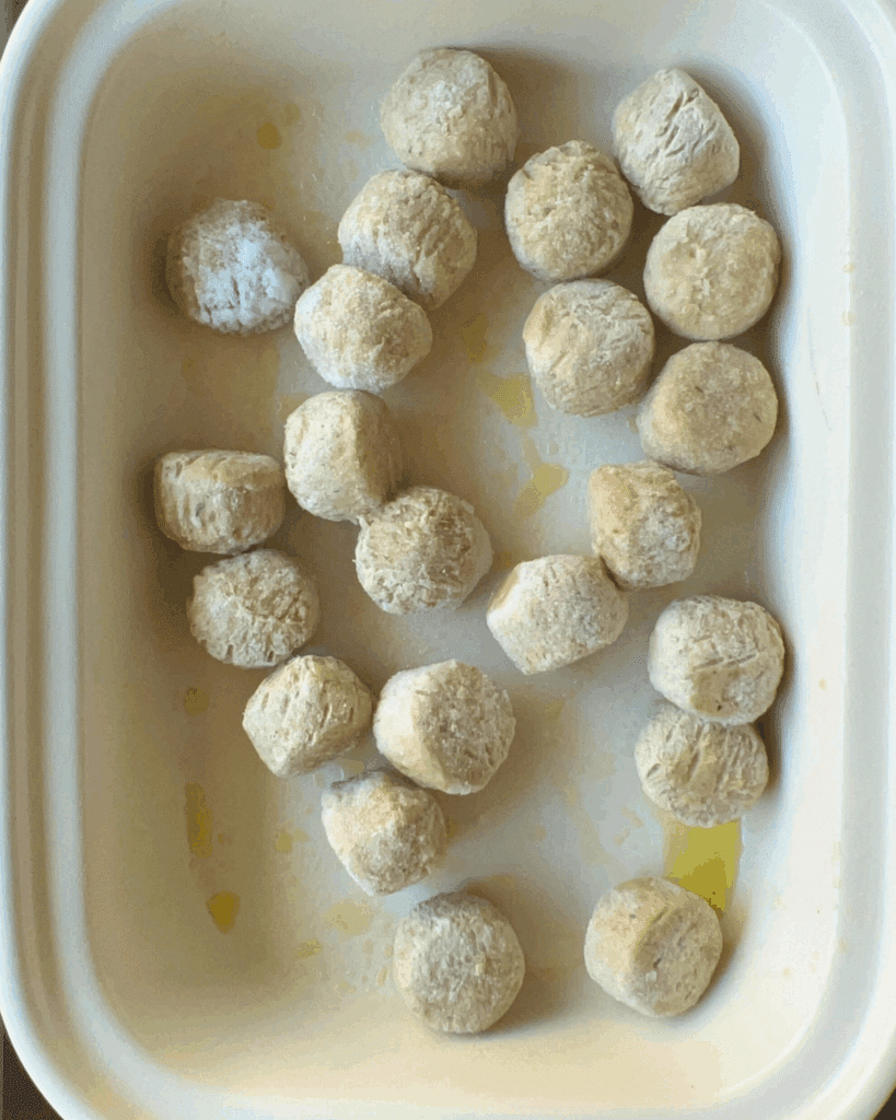 frozen chicken meatballs in a greased slow cooker