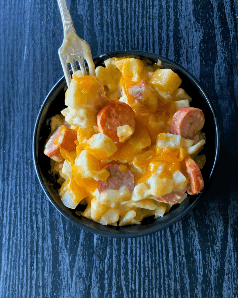 Looking down on a bowl of kielbasa and cheesy potatoes