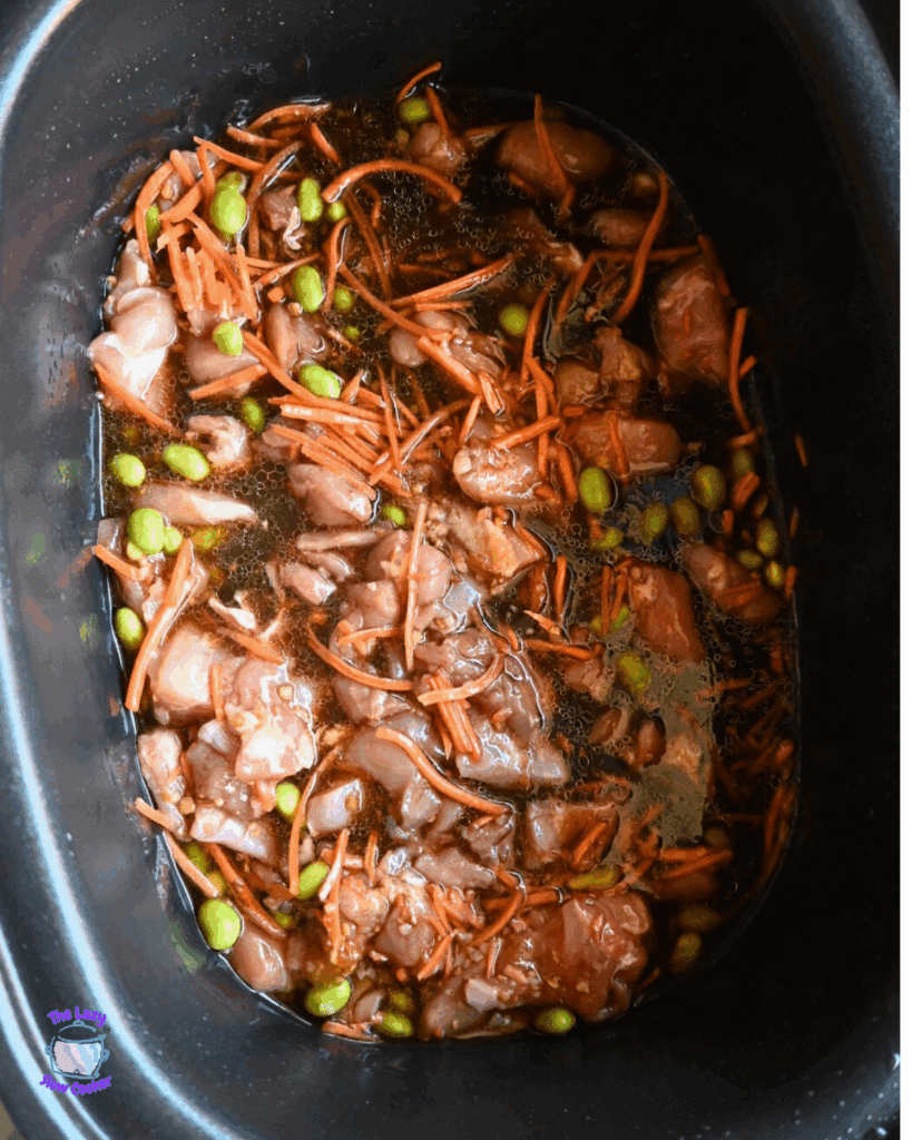 sesame chicken ingredients in a slow cooker stirred together waiting to be cooked.