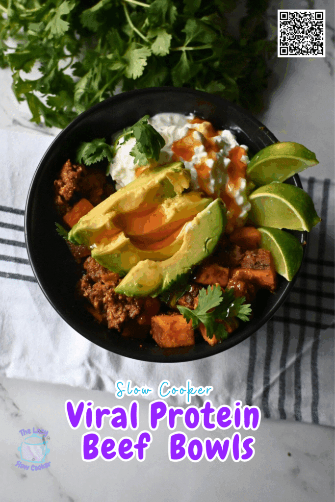A black bowl filled with beef, sweet potatoes, avocado slices, cottage cheese, cilantro, and lime wedges sits on a striped cloth. The text Slow Cooker Viral Protein Beef Bowls appears at the bottom.