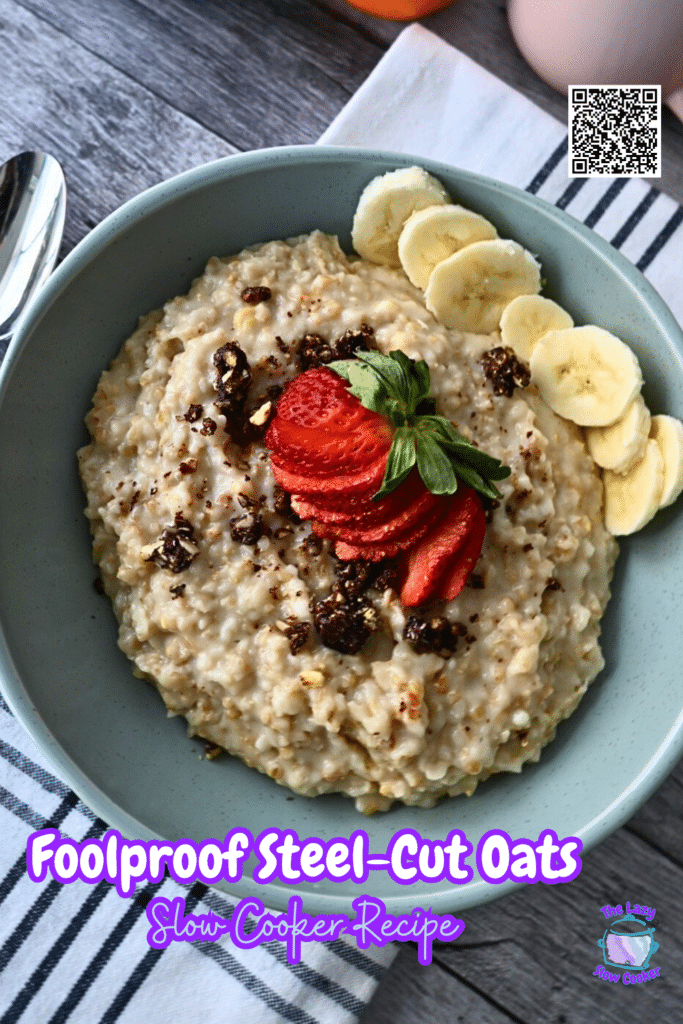 A bowl of steel-cut oats with bananas, strawberries, and raisins rests on a striped napkin beside a spoon. Text: Foolproof Slow Cooker Oats.