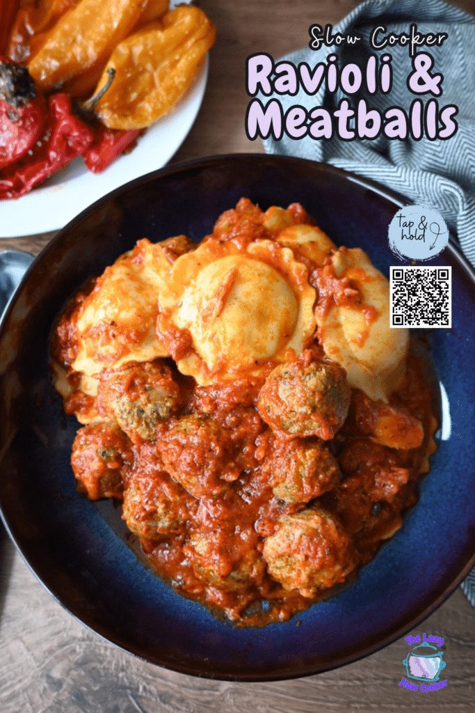 A blue bowl of ravioli and meatballs in tomato sauce sits next to stuffed peppers. Text reads “Slow Cooker Ravioli & Meatballs.”.