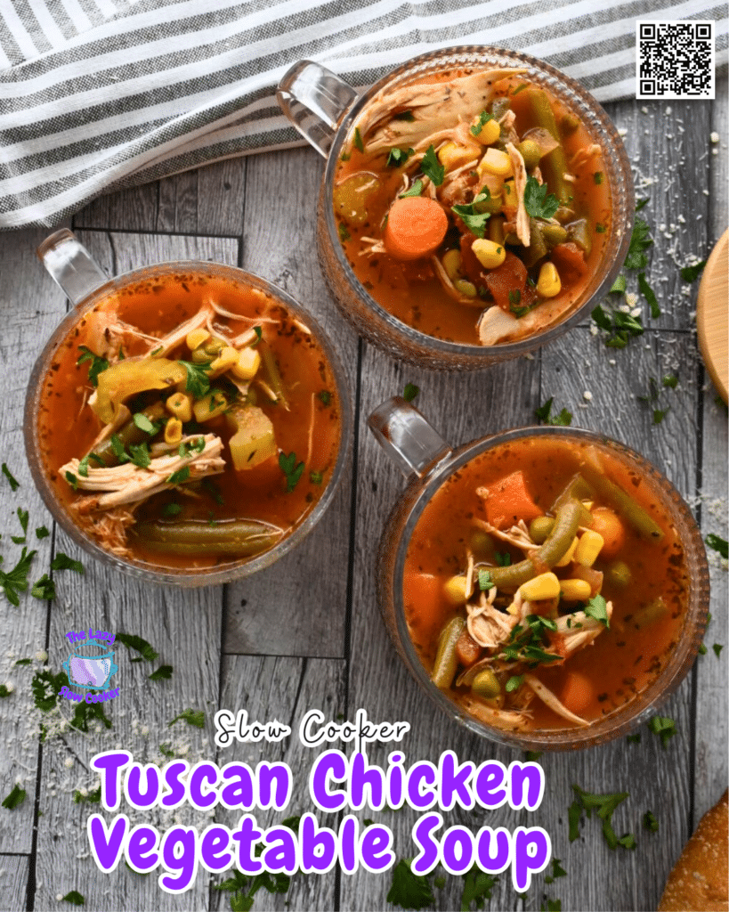 Three glass mugs of chunky vegetable soup with parsley and celery garnish sit on a wooden table, parsley scattered around