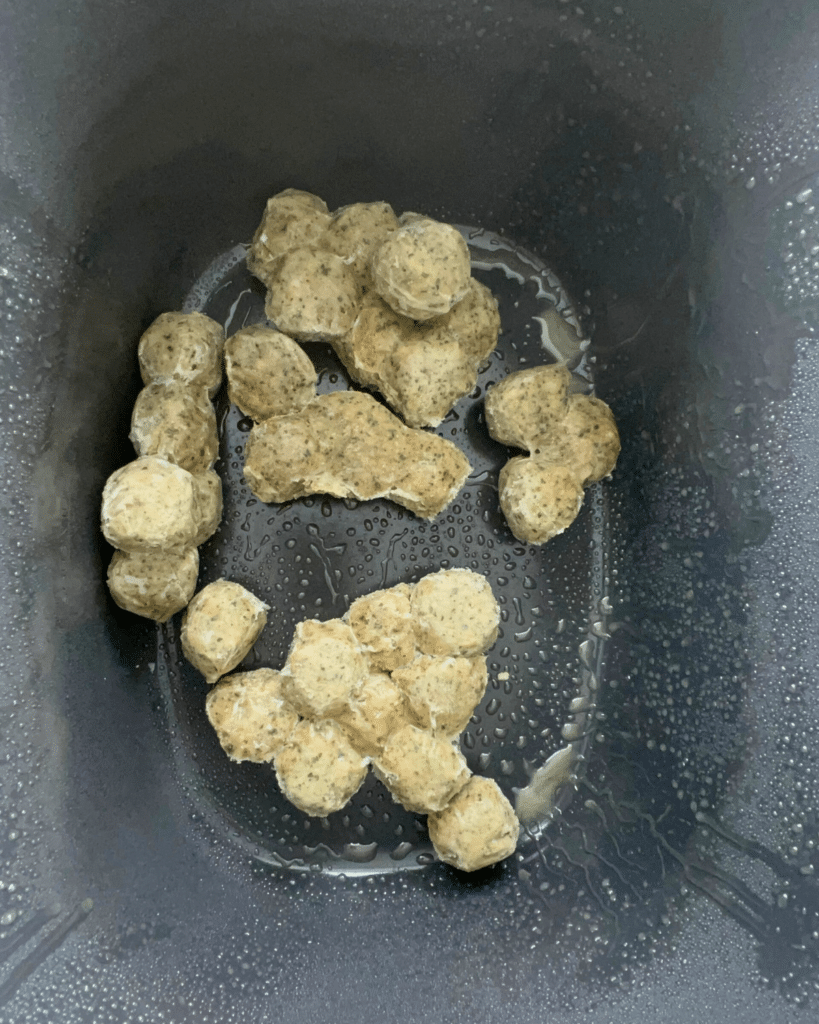 frozen meatballs in a greased slow cooker