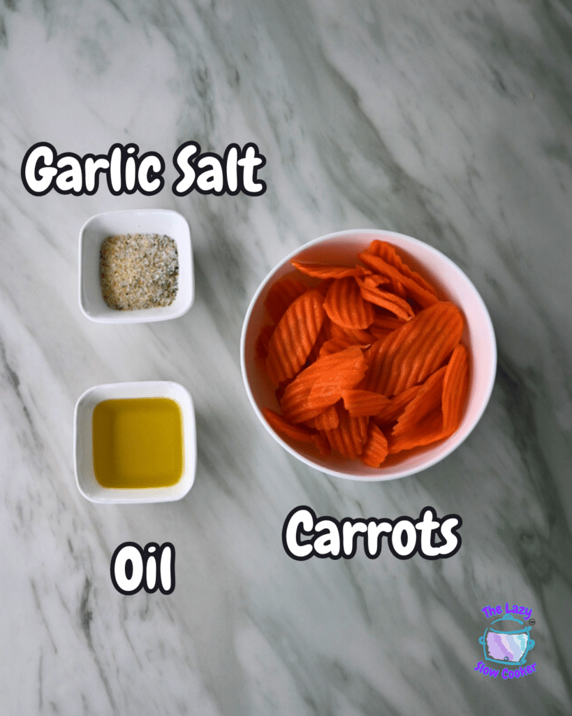 On a marble counter, labeled bowls hold crinkle-cut carrots, garlic salt, and oil—ingredients for air fryer carrots.