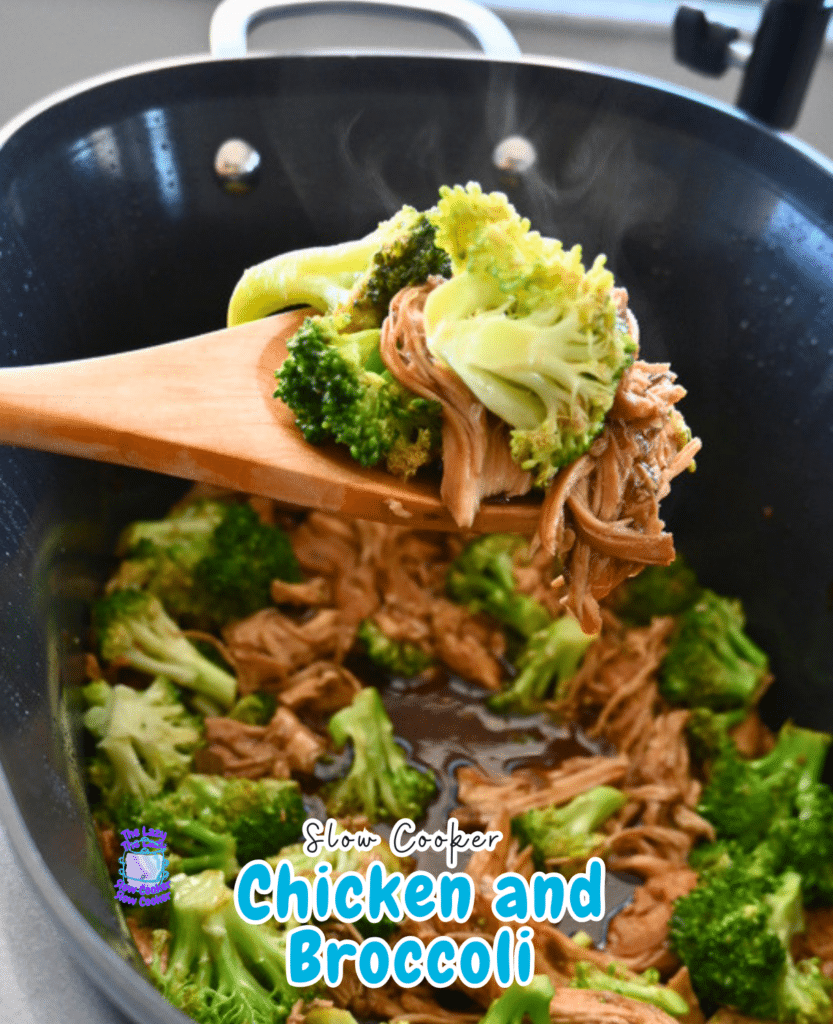 A wooden spoon lifts shredded chicken and broccoli from a steaming black slow cooker with savory sauce, showing a chicken and broccoli recipe