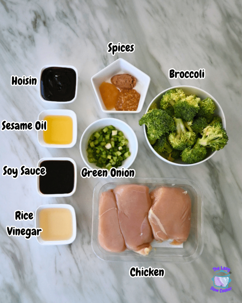 On a marble counter, labeled ingredients for slow cooker chicken stir fry, including broccoli, green onions, chicken, sauces, and spices.